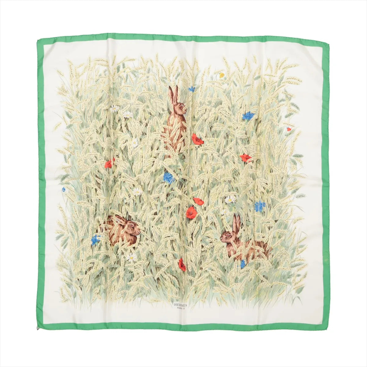 Hermès Carré 90 "Lapins Dans un Champ de Blé" silk handkerchief featuring detailed illustrations of rabbits hiding in a golden wheat field with red poppies and blue wildflowers, framed by a green border, laid flat against a white background.