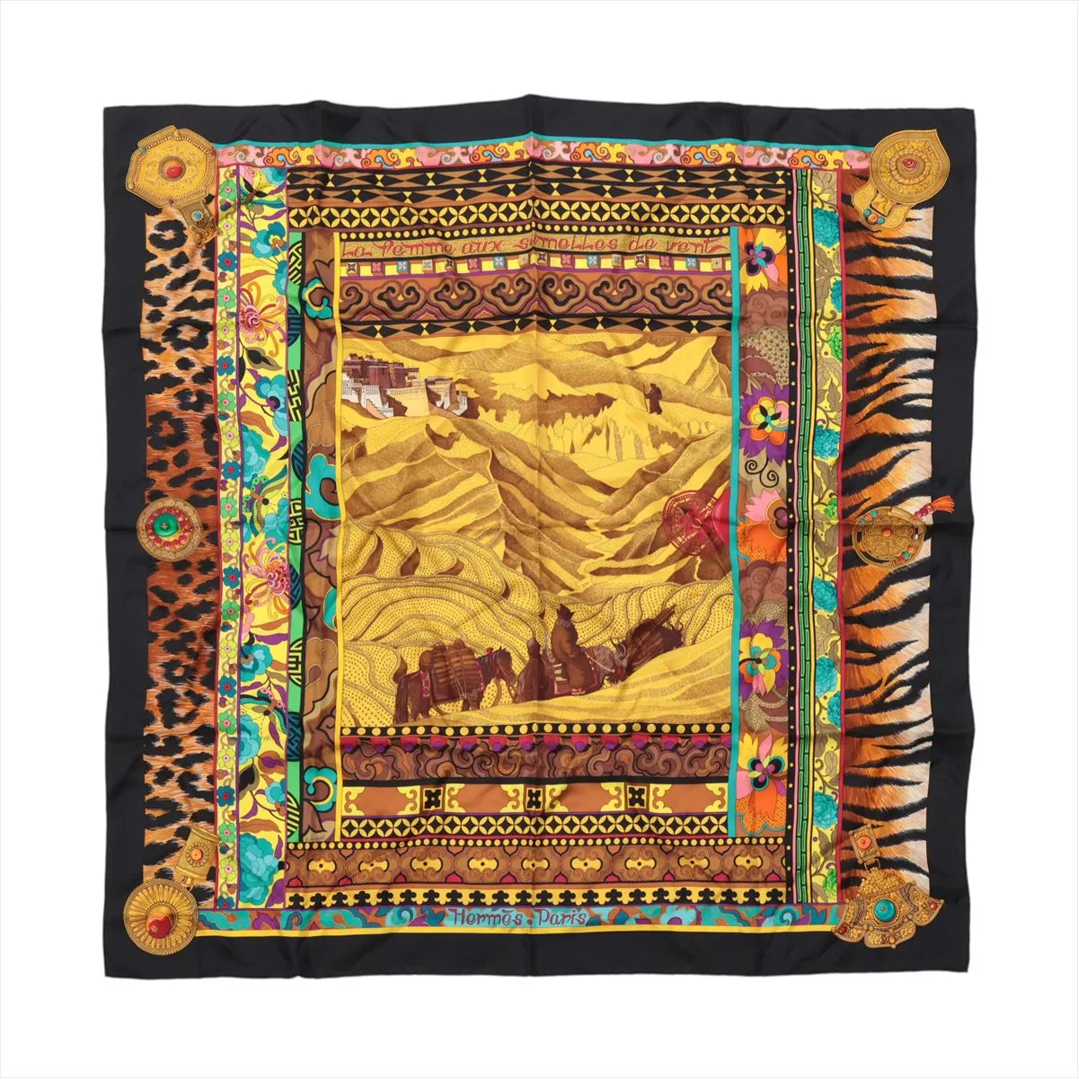 Hermès Carré 90 La Femme aux Semelles de Vent silk scarf with black border, golden landscape, floral panels, leopard and tiger-print details.