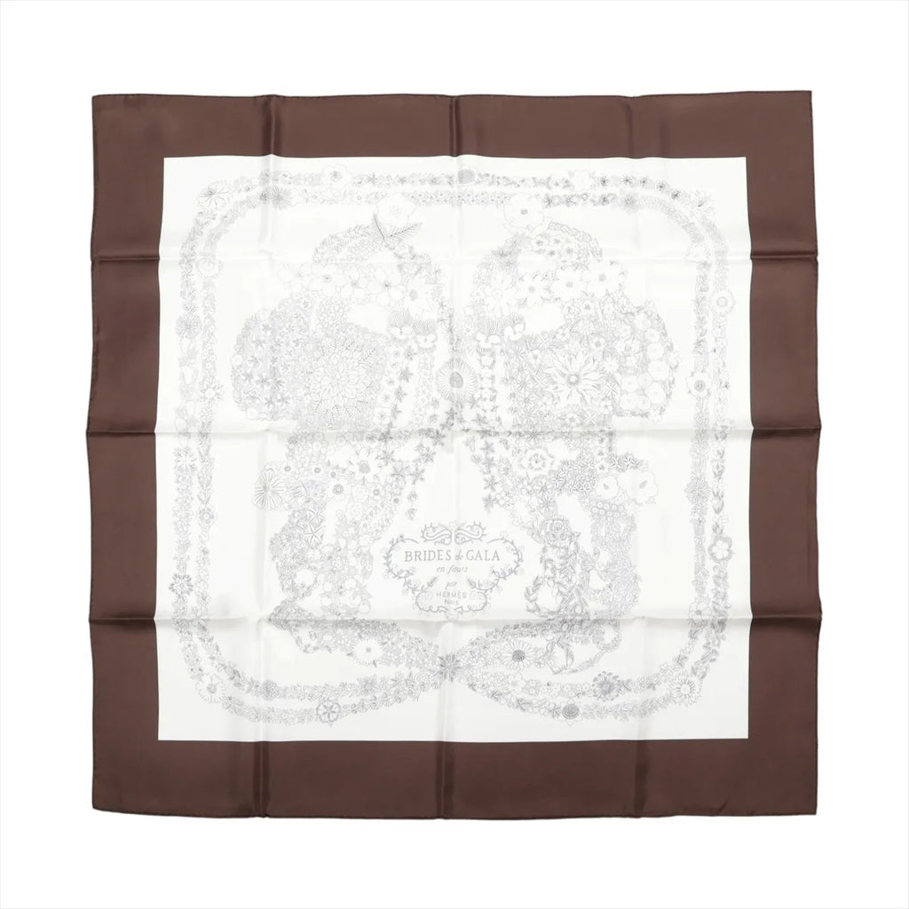 Hermès Brides de Gala en Fleurs silk scarf with a dark brown border, ivory center and intricate pale floral illustration.