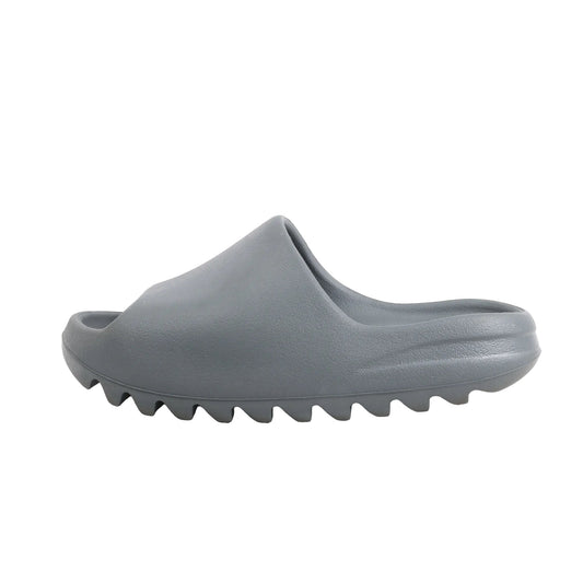 Side view of Adidas Yeezy "Slate Marine" Sandal Slide in gray, size 40 EU, showing the smooth one-piece molded EVA upper and chunky ridged sole, displayed against a white background.