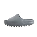 Side view of Adidas Yeezy "Slate Marine" Sandal Slide in gray, size 40 EU, showing the smooth one-piece molded EVA upper and chunky ridged sole, displayed against a white background.
