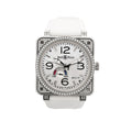 Bell & Ross square stainless steel watch with white dial, black Arabic numerals, date window, power reserve gauge, diamond-set bezel and case details, and white rubber strap.