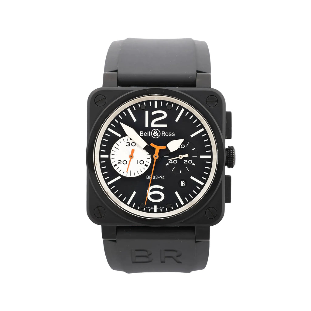 Front view of Bell & Ross BR 03-94 watch with matte black square case, black dial with white markers and large 12 and 6, orange accents, chronograph subdials, date window, and black rubber strap.