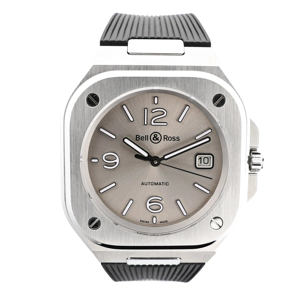 Bell & Ross BR05 BR05A-GR-ST/SRB watch featuring a brushed stainless steel square case, gray sunburst dial with white markers, date window at 3 o'clock, and textured black rubber strap.