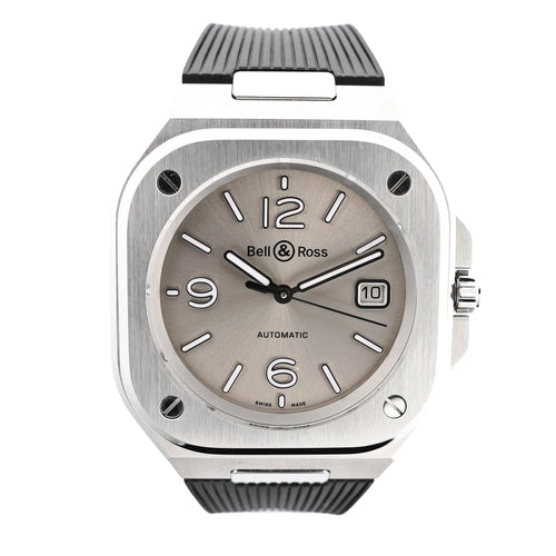 Bell & Ross BR05 BR05A-GR-ST/SRB watch featuring a brushed stainless steel square case, gray sunburst dial with white markers, date window at 3 o'clock, and textured black rubber strap.