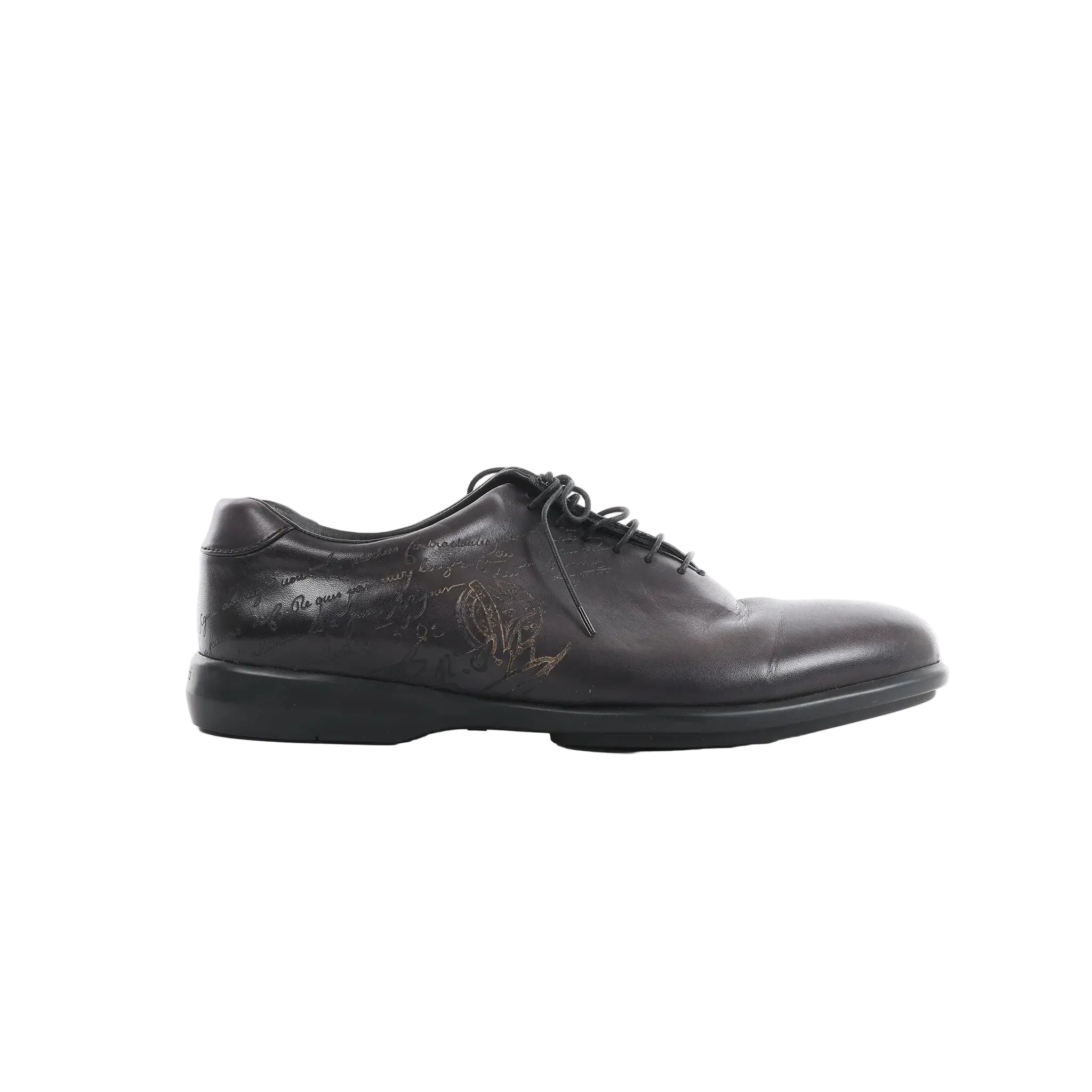 Berluti black leather lace-up shoe with calligraphy detailing on the side and low-profile black sole on white background