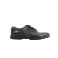 Berluti black leather lace-up shoe with calligraphy detailing on the side and low-profile black sole on white background