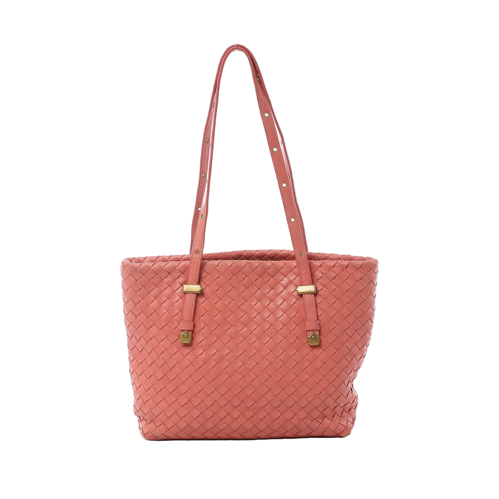 Bottega Veneta pink Intrecciato woven leather shoulder bag with slim shoulder straps, gold-tone hardware, and structured tote silhouette on white background.