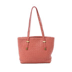 Bottega Veneta pink Intrecciato woven leather shoulder bag with slim shoulder straps, gold-tone hardware, and structured tote silhouette on white background.