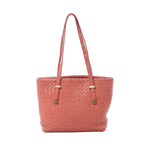Bottega Veneta pink Intrecciato woven leather shoulder bag with slim shoulder straps, gold-tone hardware, and structured tote silhouette on white background.