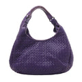 Bottega Veneta Campana shoulder bag in purple woven Intrecciato leather with a rounded silhouette, twin shoulder straps and dark metal rings.