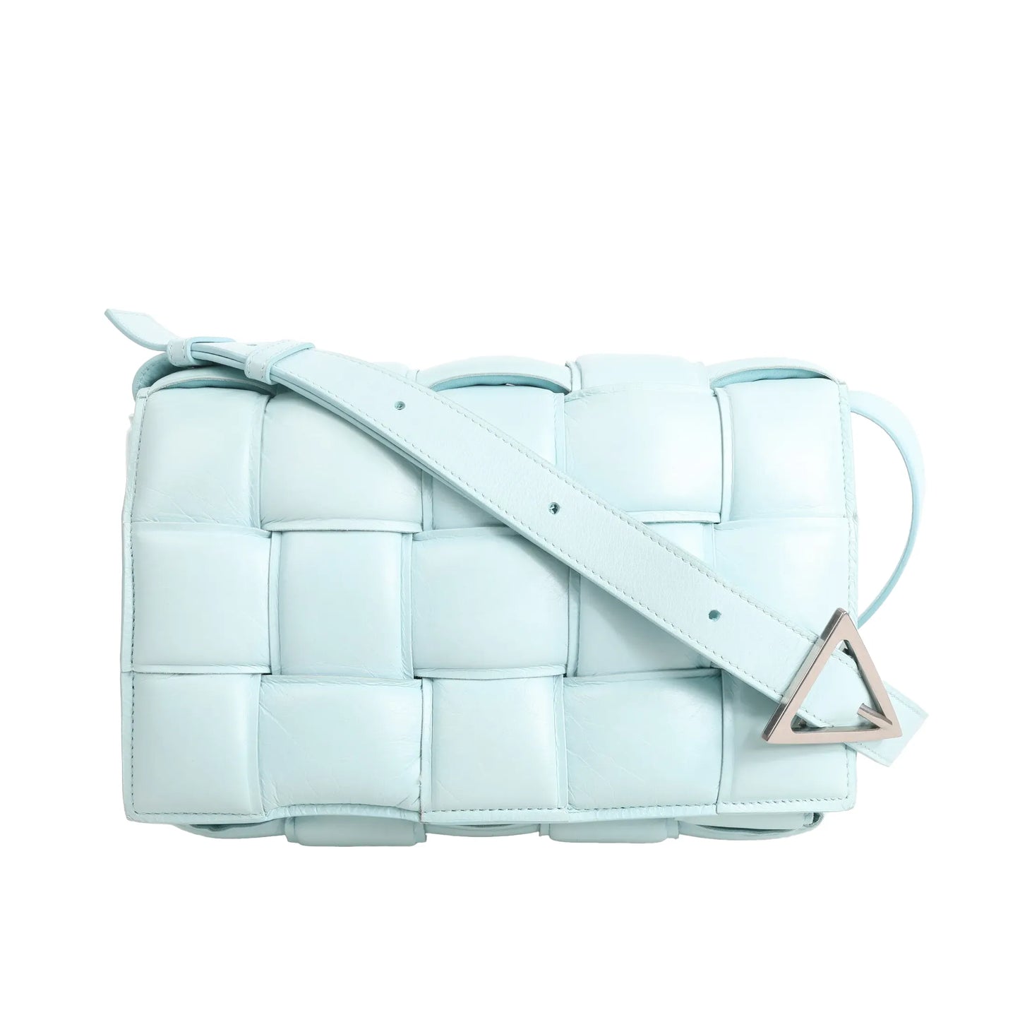 Bottega Veneta Padded Cassette shoulder bag in soft blue leather featuring oversized Intrecciato weave, padded structure, adjustable leather strap, and signature silver-tone triangle buckle.