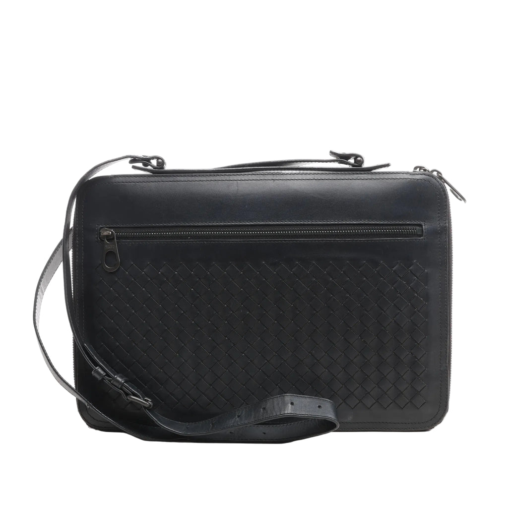 Black Bottega Veneta Intrecciato leather crossbody bag with a woven front panel, top zipper closure, horizontal front zip pocket, and adjustable strap, shown on a white background.