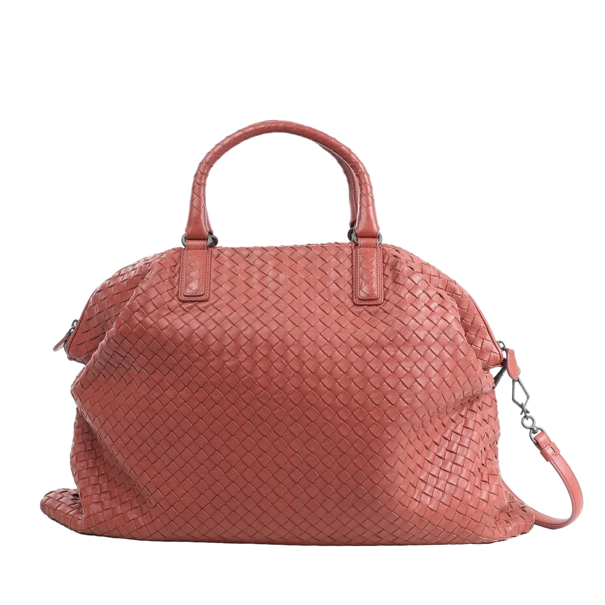 Bottega Veneta Intrecciato handbag in dusty red woven leather with dual top handles, detachable shoulder strap, and soft structured shape against a white background.