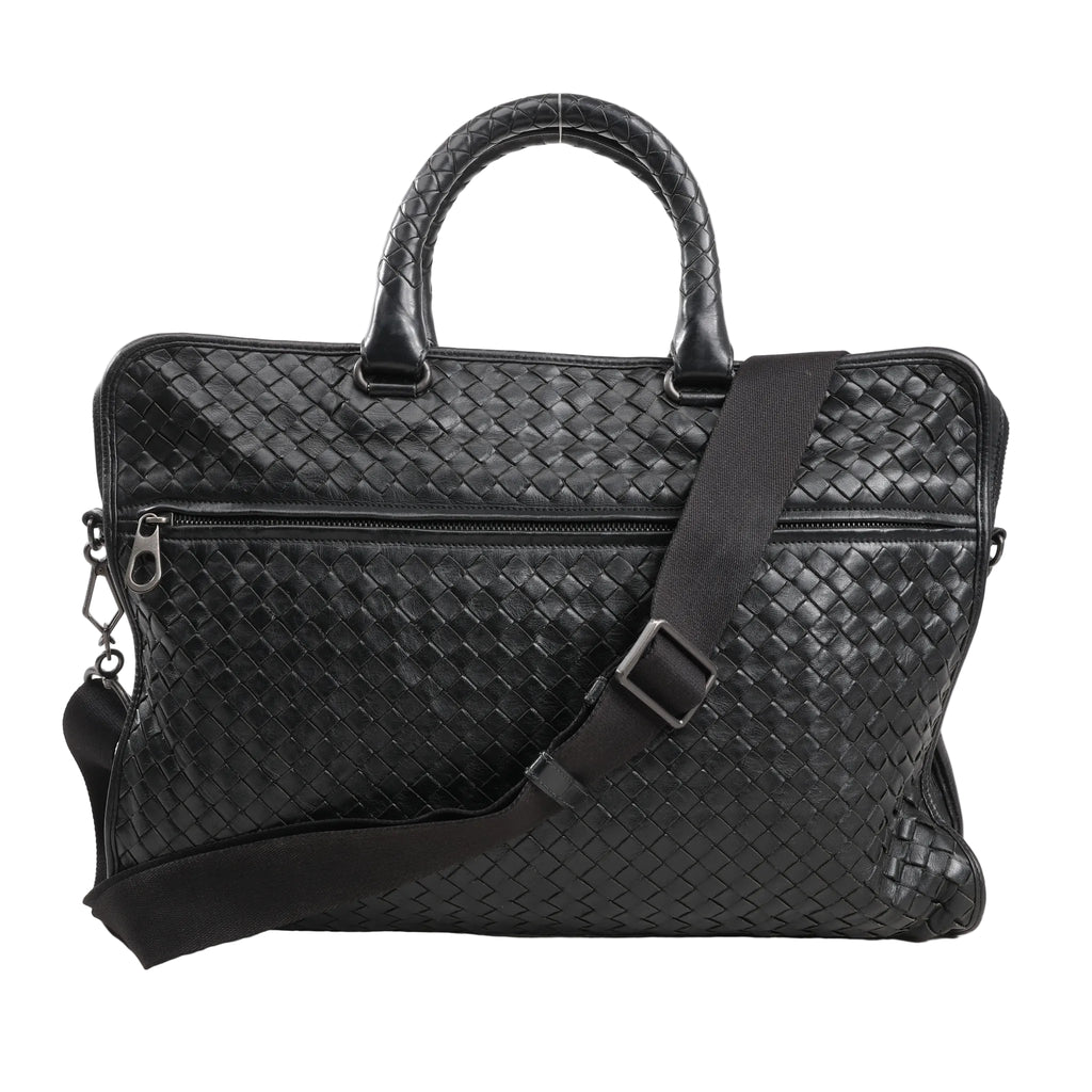 Bottega Veneta Intrecciato Leather 2Way Handbag in black with signature woven leather pattern, dual rounded handles, front zip pocket, and adjustable shoulder strap, displayed against a white background.