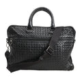 Bottega Veneta Intrecciato Leather 2Way Handbag in black with signature woven leather pattern, dual rounded handles, front zip pocket, and adjustable shoulder strap, displayed against a white background.