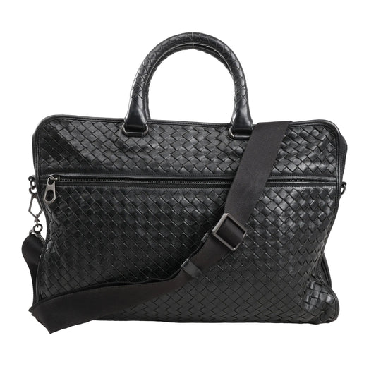 Bottega Veneta Intrecciato Leather 2Way Handbag in black with signature woven leather pattern, dual rounded handles, front zip pocket, and adjustable shoulder strap, displayed against a white background.