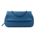 Bottega Veneta shoulder bag in blue Intrecciato woven leather featuring a flap front, dark gunmetal chain strap, and soft rounded silhouette.
