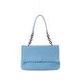 Light blue Bottega Veneta Intrecciato woven leather shoulder bag with a flap front, dark chain links and matching blue leather strap on a grey background.