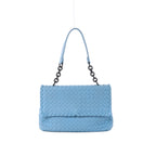 Light blue Bottega Veneta Intrecciato woven leather shoulder bag with a flap front, dark chain links and matching blue leather strap on a grey background.