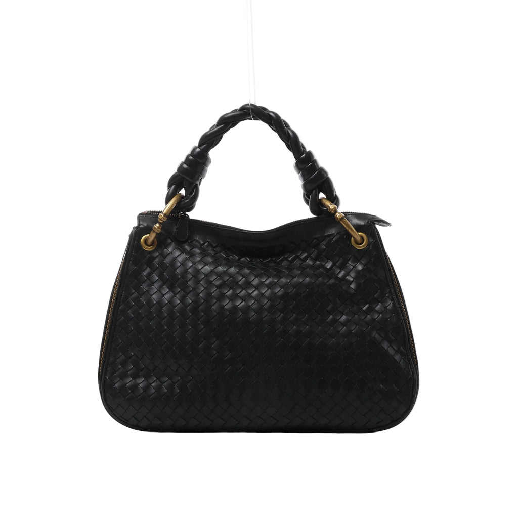 Front view of Bottega Veneta black woven leather bag with a chunky braided handle, gold-tone handle attachments and zip detailing along the sides.