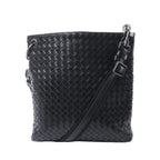 Bottega Veneta black Intrecciato woven leather messenger bag with an adjustable crossbody strap, top zip closure and dark-tone hardware.