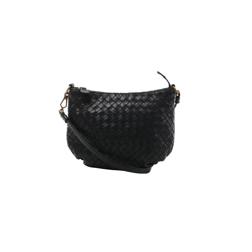 A black Bottega Veneta shoulder bag in signature Intrecciato woven leather, featuring a curved zip-top design and a slender leather shoulder strap.