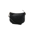 A black Bottega Veneta shoulder bag in signature Intrecciato woven leather, featuring a curved zip-top design and a slender leather shoulder strap.