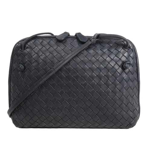 CELINE Nano Luggage 2Way handbag in black and white grained leather with top handles, front zip pocket, and detachable shoulder strap.