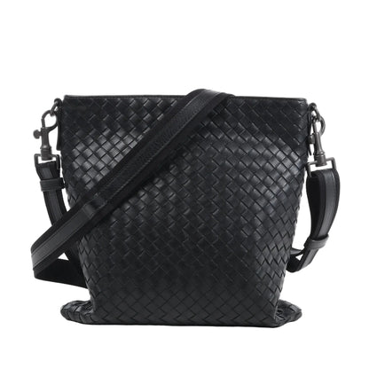 Bottega Veneta VN Intrecciato crossbody messenger bag in black woven leather with adjustable shoulder strap, rectangular shape, and minimalist design against a white background.
