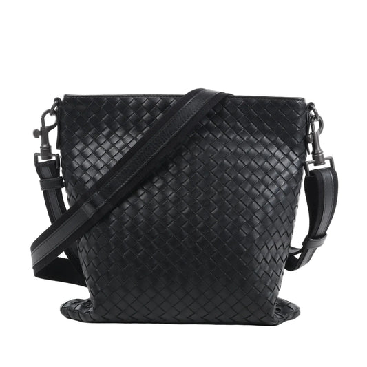 Bottega Veneta VN Intrecciato crossbody messenger bag in black woven leather with adjustable shoulder strap, rectangular shape, and minimalist design against a white background.