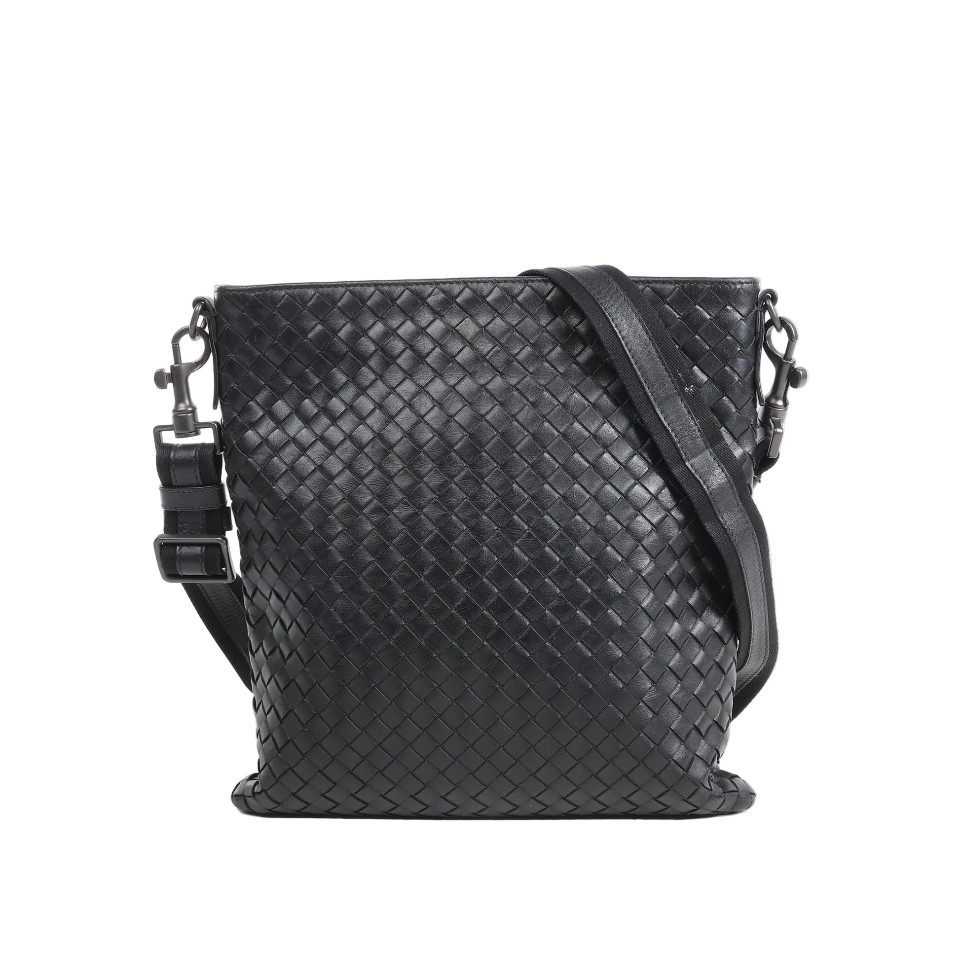 Bottega Veneta VN Nappa Intrecciato crossbody messenger bag in black woven leather with adjustable strap, slim rectangular shape, and minimalist design against a white background.