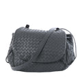 Gray Bottega Veneta Intrecciato leather crossbody bag with woven body, curved flap and long shoulder strap on a white background.