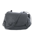 Gray Bottega Veneta Intrecciato leather crossbody bag with woven body, curved flap and long shoulder strap on a white background.