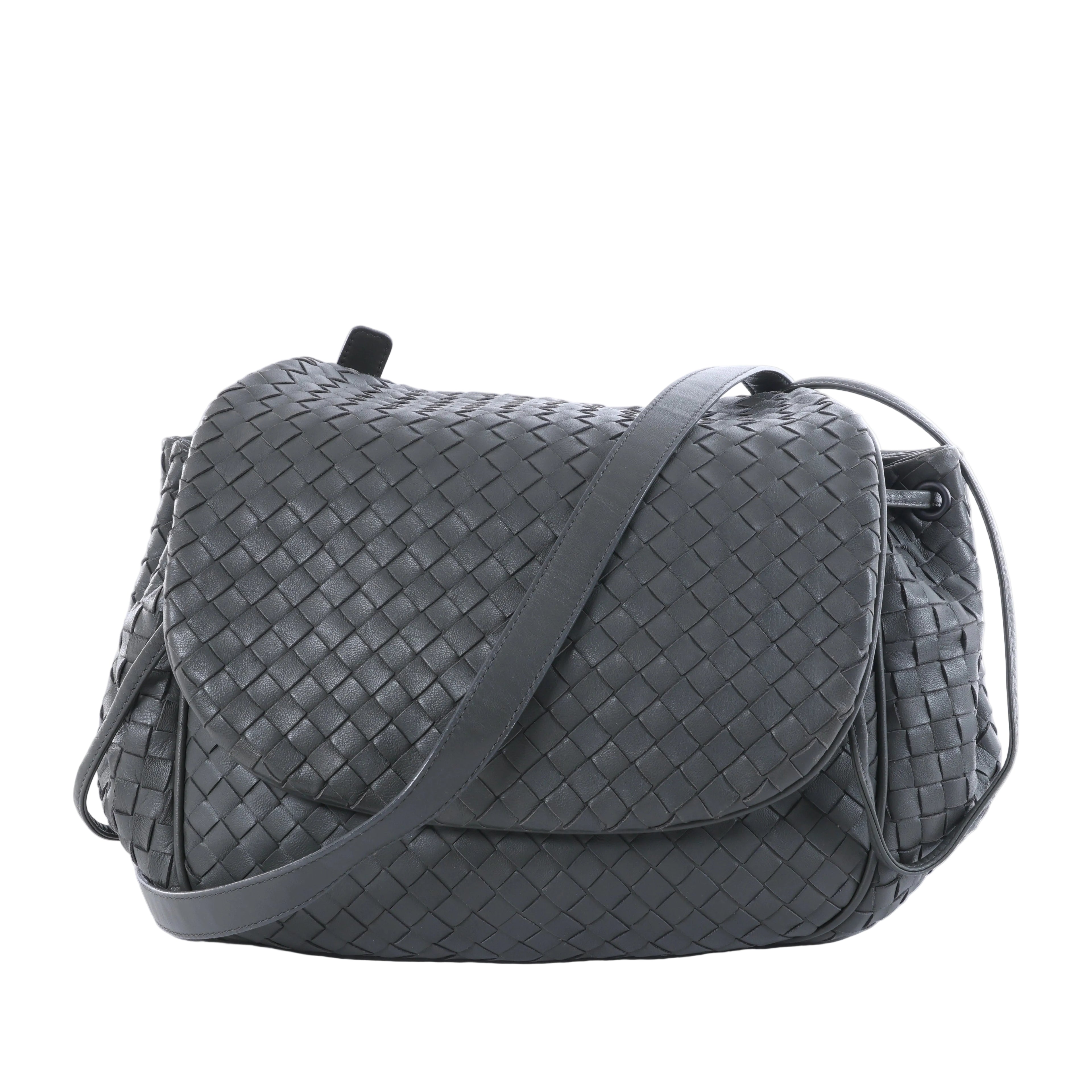Gray Bottega Veneta Intrecciato leather crossbody bag with woven body, curved flap and long shoulder strap on a white background.