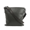 Bottega Veneta Nappa Intrecciato VN Crossbody Messenger Bag in green woven leather with an adjustable leather and fabric shoulder strap and gunmetal-tone hardware, displayed upright against a white background.