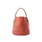 Bottega Veneta Intrecciato woven leather shoulder bag in pink-coral with a slouchy bucket silhouette and single top handle on a white background.