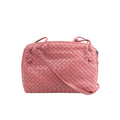 Pink Bottega Veneta Nodini crossbody bag with woven Intrecciato leather, rounded rectangular shape, knotted details and slim shoulder strap.