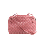 Pink Bottega Veneta Nodini crossbody bag with woven Intrecciato leather, rounded rectangular shape, knotted details and slim shoulder strap.