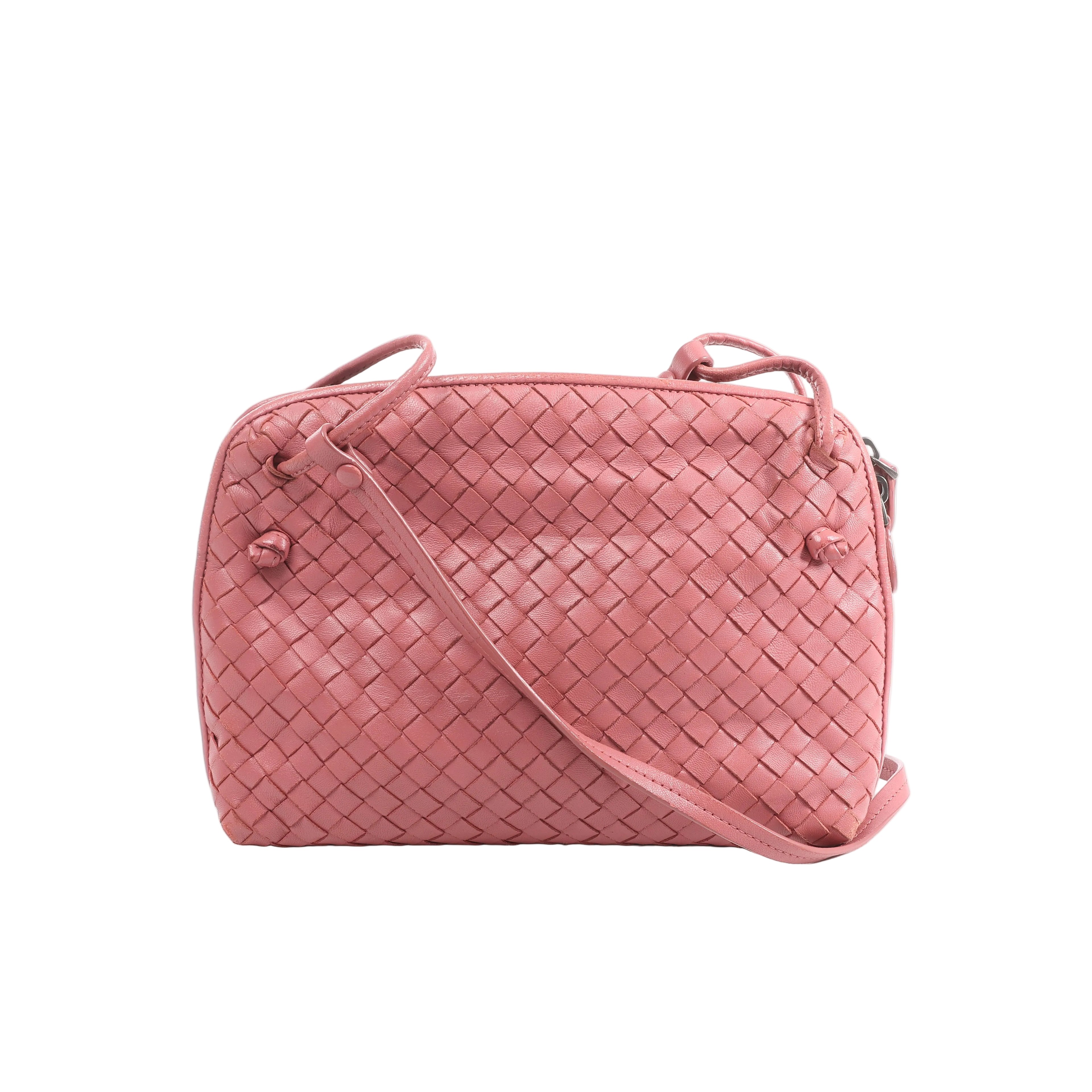 Pink Bottega Veneta Nodini crossbody bag with woven Intrecciato leather, rounded rectangular shape, knotted details and slim shoulder strap.