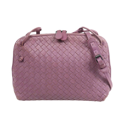 Bottega Veneta Nodini Intrecciato Leather Crossbody Bag in purple lambskin with signature woven pattern, adjustable shoulder strap, and top zip closure, displayed on a white background.