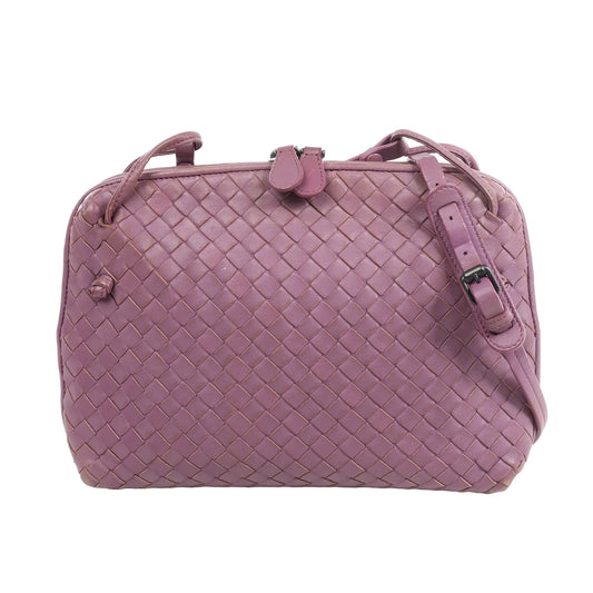 Bottega Veneta Nodini Intrecciato Leather Crossbody Bag in purple lambskin with signature woven pattern, adjustable shoulder strap, and top zip closure, displayed on a white background.