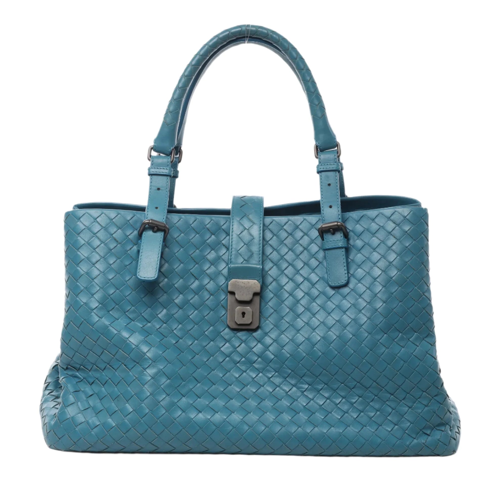Front view of Bottega Veneta Intrecciato Roma Leather Handbag in blue woven leather with double top handles, adjustable buckle details, and signature lock closure, displayed against a white background.