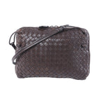 Bottega Veneta Nodini brown Intrecciato woven leather crossbody bag with slim shoulder strap on a white background.