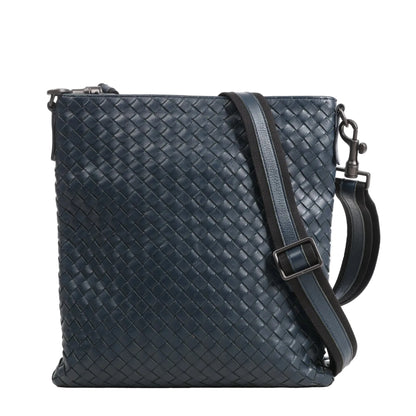 Bottega Veneta VN Intrecciato crossbody messenger bag in navy blue leather featuring the brand’s signature woven pattern, an adjustable shoulder strap with leather and fabric detail, and matte black-tone hardware.