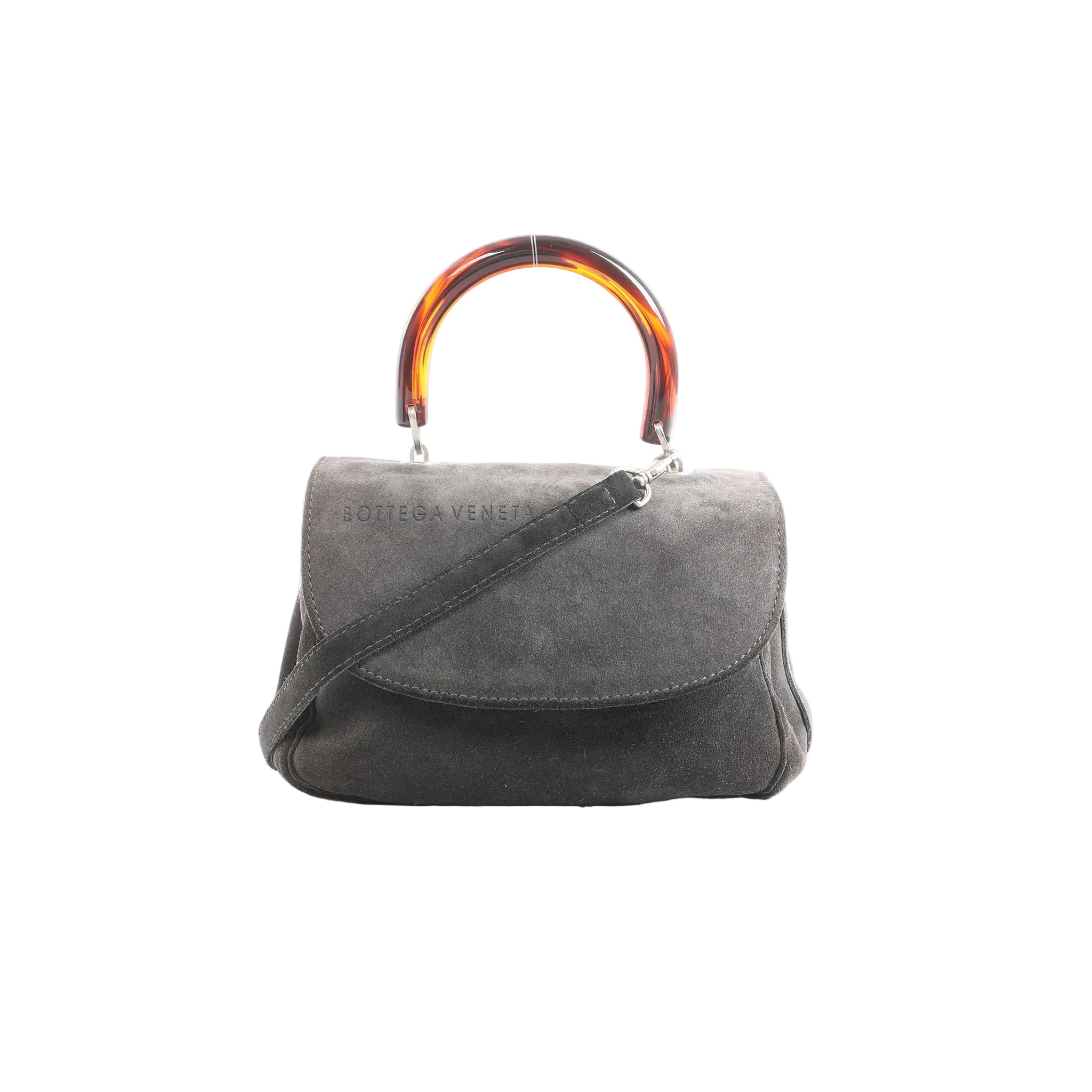 Bottega Veneta gray suede handbag with tortoiseshell-effect top handle, flap front, and detachable shoulder strap, front view on white background.