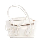 Bottega Veneta Arco Mini handbag in white leather with oversized Intrecciato weave, rounded top handles and an adjustable shoulder strap.