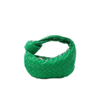 Bottega Veneta Mini Jodie handbag in bright green woven leather with a curved body and signature knotted top handle.