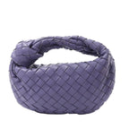 Bottega Veneta Jodie Mini handbag in purple woven Intrecciato leather with a knotted top handle and soft rounded shape.