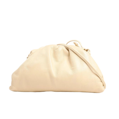 Bottega Veneta Mini The Pouch Crossbody bag in soft beige leather with a slouchy silhouette and thin matching leather strap, displayed on a white background.